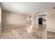 Open living room with tile floors flowing to a kitchen with white cabinets and black appliances at 3632 W Mariposa St, Phoenix, AZ 85019
