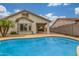 The covered patio connects to the refreshing pool for outdoor relaxation at 3724 E Derringer Way, Gilbert, AZ 85297