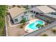 Aerial backyard view of a home showcasing a pool, covered patio, desert landscaping, and privacy fence at 3724 E Derringer Way, Gilbert, AZ 85297