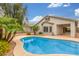 The beautiful backyard has a private pool, palm trees, and an outdoor living space at 3724 E Derringer Way, Gilbert, AZ 85297