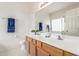 Bright bathroom featuring a double vanity, a wide mirror and stylish nautical decor at 3724 E Derringer Way, Gilbert, AZ 85297