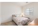 Cozy bedroom with a patterned comforter, side table, and a bedside lamp at 3724 E Derringer Way, Gilbert, AZ 85297