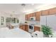 Modern kitchen with a breakfast bar, stainless steel sink, and tile flooring at 3724 E Derringer Way, Gilbert, AZ 85297