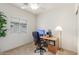 Functional office space with a computer desk, rolling chair, and a floor lamp at 3724 E Derringer Way, Gilbert, AZ 85297