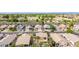 An elevated view capturing single-Gathering homes featuring desert landscaping, driveways, and tile roofs, some with solar panels at 3724 E Derringer Way, Gilbert, AZ 85297