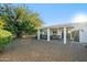 Backyard featuring a covered patio, lush landscaping, and a gravel yard at 39 E Tam Oshanter Dr, Phoenix, AZ 85022