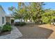 Backyard with beautiful landscaping, a large tree, and a covered patio at 39 E Tam Oshanter Dr, Phoenix, AZ 85022