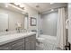 Bathroom featuring patterned tile flooring, gray vanity and shower-tub combo with white subway tiles at 39 E Tam Oshanter Dr, Phoenix, AZ 85022