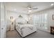 Bedroom with a ceiling fan, carpet flooring, a large window, and a comfortable bed at 39 E Tam Oshanter Dr, Phoenix, AZ 85022