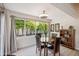 Charming dining area with a round table, backyard views, and an elegant light fixture at 39 E Tam Oshanter Dr, Phoenix, AZ 85022