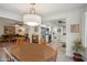 Dining room flows to the living room and a kitchen, featuring a round wooden table and overhead lighting at 39 E Tam Oshanter Dr, Phoenix, AZ 85022