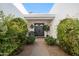 Inviting front entrance featuring double doors, lush landscaping, and a cozy seating area at 39 E Tam Oshanter Dr, Phoenix, AZ 85022