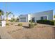 Attractive home with well-kept desert landscaping, a two-car garage, and a clean, white facade at 39 E Tam Oshanter Dr, Phoenix, AZ 85022