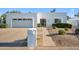 Well-maintained home with a two-car garage, desert landscaping, and a secure gated entry at 39 E Tam Oshanter Dr, Phoenix, AZ 85022