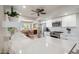 Bright open kitchen with stainless steel appliances and white countertops with a view into the dining room at 39 E Tam Oshanter Dr, Phoenix, AZ 85022