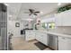A clean white kitchen features stainless steel appliances, light wood floors, and a view into the dining area at 39 E Tam Oshanter Dr, Phoenix, AZ 85022
