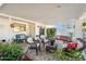 Covered patio with comfortable seating, surrounded by beautiful landscaping at 39 E Tam Oshanter Dr, Phoenix, AZ 85022