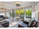 Sunroom with comfortable seating, mirrored wall, and sliding doors to the outdoors at 39 E Tam Oshanter Dr, Phoenix, AZ 85022