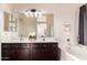 Bright bathroom boasts double sinks, soaking tub, and elegant fixtures at 4038 E Wagon Cir, Gilbert, AZ 85297