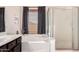 This bathroom features a soaking tub with a window and separate glass-enclosed shower at 4038 E Wagon Cir, Gilbert, AZ 85297
