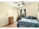 Relaxing bedroom with a cozy bed, ceiling fan, and peaceful window view at 4038 E Wagon Cir, Gilbert, AZ 85297