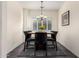 Bright dining room featuring a dark wood table, leather chairs, and a gray rug at 4038 E Wagon Cir, Gilbert, AZ 85297