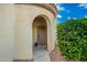 Welcoming entryway with a rounded entrance, neutral paint, and manicured landscaping at 4038 E Wagon Cir, Gilbert, AZ 85297