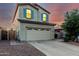 Charming two-story home with a two-car garage, desert landscaping, and inviting curb appeal at sunset at 4038 E Wagon Cir, Gilbert, AZ 85297