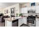 Bright kitchen with white cabinets, stainless steel appliances, and a granite countertop island at 4038 E Wagon Cir, Gilbert, AZ 85297