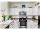 Bright kitchen featuring white cabinets, stainless steel appliances, and a granite countertop at 4038 E Wagon Cir, Gilbert, AZ 85297