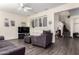 Cozy living room featuring hardwood floors, plantation shutters, and staircase access at 4038 E Wagon Cir, Gilbert, AZ 85297