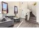 Bright living room with modern gray sofa, wood floors, and natural light, perfect for relaxation and entertaining at 4038 E Wagon Cir, Gilbert, AZ 85297