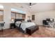 Spacious main bedroom featuring a ceiling fan, leather storage ottoman, and a window bench at 4038 E Wagon Cir, Gilbert, AZ 85297