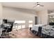 Spacious main bedroom featuring a vaulted ceiling, ceiling fan, and an office space at 4038 E Wagon Cir, Gilbert, AZ 85297