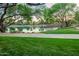 Scenic pond view surrounded by lush greenery and mature trees providing a peaceful community space at 4038 E Wagon Cir, Gilbert, AZ 85297