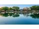 Community pond reflecting the clubhouse in a tranquil natural setting at 4038 E Wagon Cir, Gilbert, AZ 85297