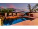 Lush backyard pool area with a hot tub, tanning deck, and landscape plants at 4038 E Wagon Cir, Gilbert, AZ 85297