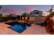 Backyard pool and patio area includes a spa, seating, and surrounding greenery at 4038 E Wagon Cir, Gilbert, AZ 85297
