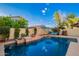 Lush backyard pool area with a hot tub, tanning deck, and landscape plants at 4038 E Wagon Cir, Gilbert, AZ 85297