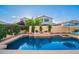 Lush backyard pool area with a hot tub, tanning deck, and landscape plants at 4038 E Wagon Cir, Gilbert, AZ 85297