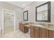Bathroom with granite countertops, dual sinks, and walk in closet at 41627 N Cedar Chase Rd, Anthem, AZ 85086