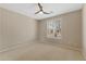 Cozy bedroom with a neutral color palette, large window, and ceiling fan at 41627 N Cedar Chase Rd, Anthem, AZ 85086