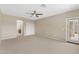 Bedroom featuring plush carpet, ceiling fan, closet, and entry to bathroom at 41627 N Cedar Chase Rd, Anthem, AZ 85086
