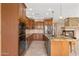 Elegant kitchen with stainless steel appliances, granite countertops, and custom cabinetry at 41627 N Cedar Chase Rd, Anthem, AZ 85086