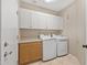 Functional laundry room with washer, dryer, built-in cabinets, and countertop space at 41627 N Cedar Chase Rd, Anthem, AZ 85086