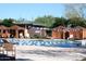 Outdoor pool area with brown tented cabanas for shade and blue and white bunting above the pool at 41627 N Cedar Chase Rd, Anthem, AZ 85086