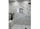Sleek, tiled bathroom with a black rainfall shower head and mosaic tile at 4540 N 35Th N Ave, Phoenix, AZ 85017