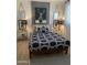 Stylishly decorated bedroom with a black and white patterned duvet, bedside tables, and stag artwork at 4540 N 35Th N Ave, Phoenix, AZ 85017
