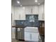 Stylish kitchen sink with modern fixtures and tile backsplash, complemented by ample counter space at 4540 N 35Th N Ave, Phoenix, AZ 85017
