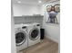 Well-lit laundry room with a front-load washer, dryer, and whimsical wall art at 4540 N 35Th N Ave, Phoenix, AZ 85017